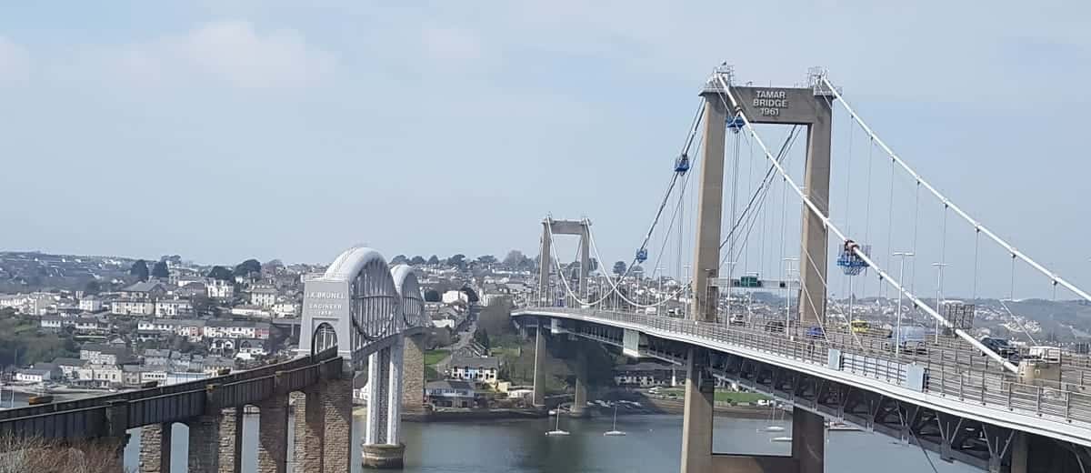 The Royal Albert Bridge and the Tamar Bridge crossing the river at Saltash, with the town rising on the hillside behind.